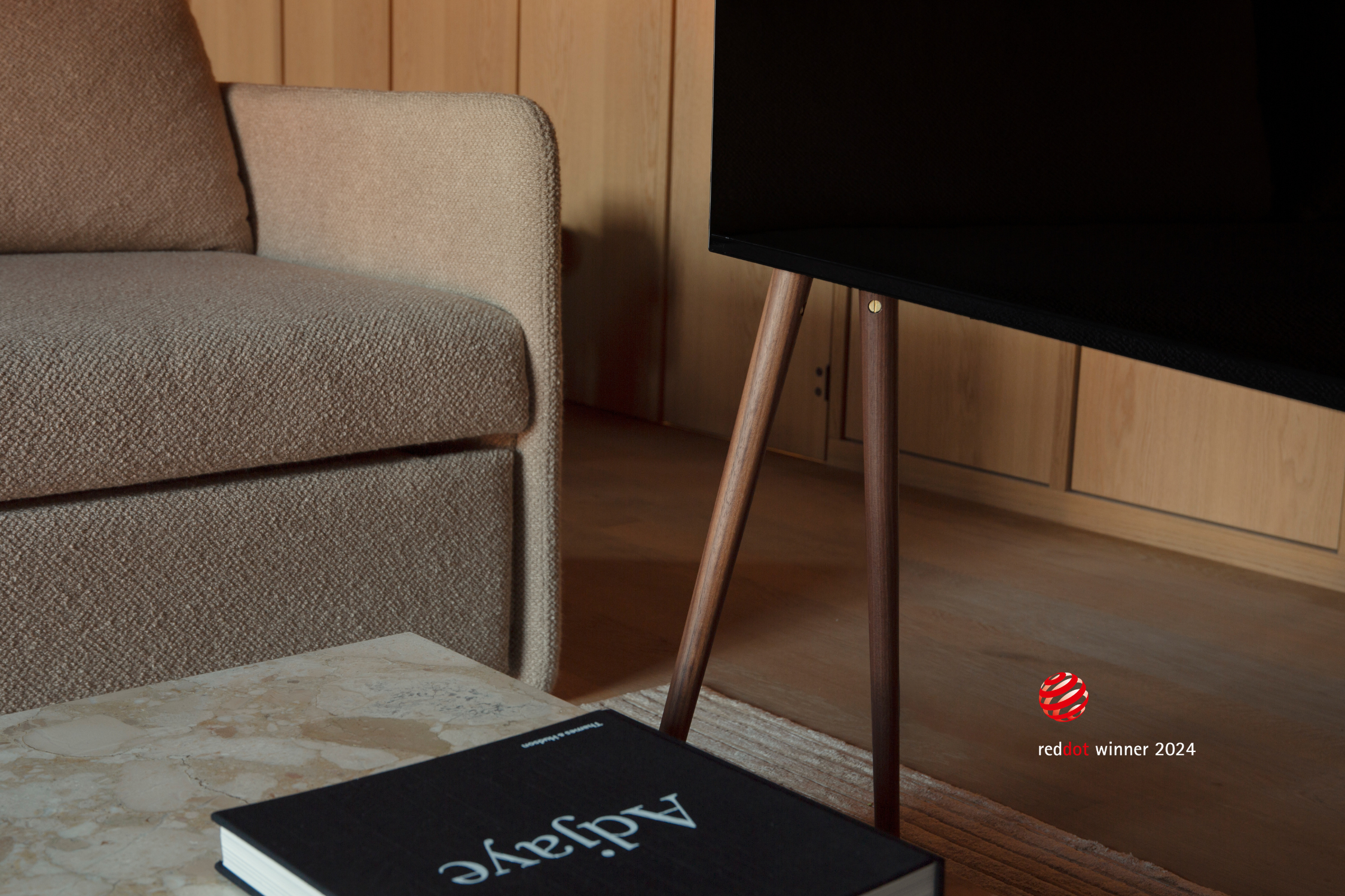 A close-up view of freestanding JALG TV stand, Red Dot Winner 2024, desktop layout